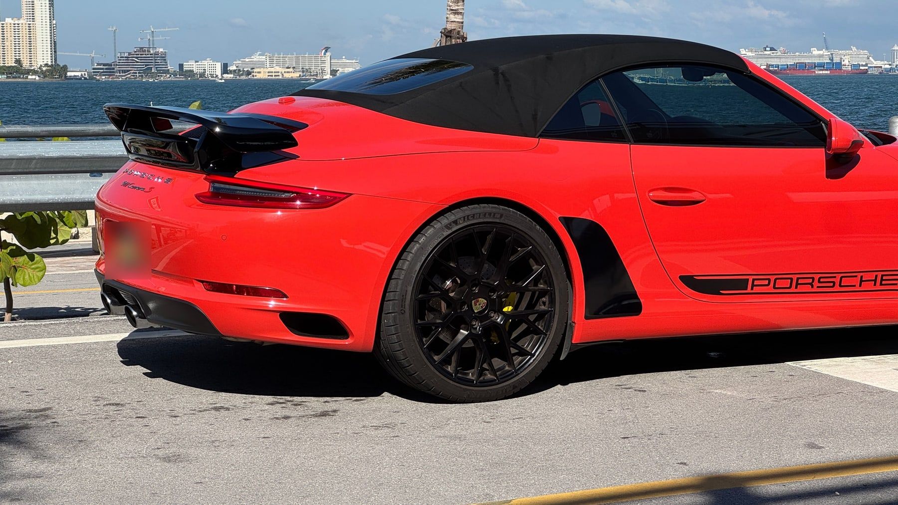 The Porsche from the side, showing the spoiler and the body line